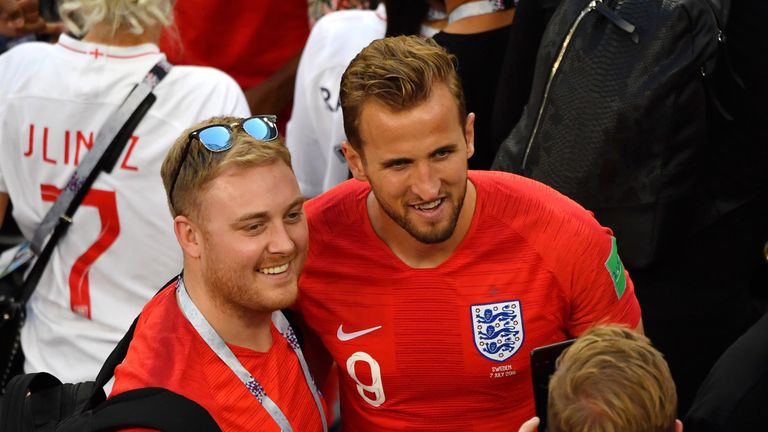 Kane poses for pictures with fans after England's win over Sweden