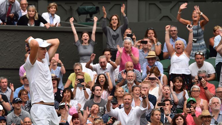 Spectators cheers as South Africa's Kevin Anderson reacts after winning against US player John Isner during the final set tie-break of their men's singles semi-final match on the eleventh day of the 2018 Wimbledon Championships at The All England Lawn Tennis Club in Wimbledon, southwest London, on July 13, 2018