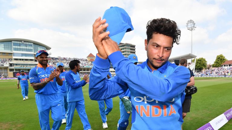 India's Kuldeep Yadav (R) acknowledges the applause of the crowd as he leaves the field after the England Innings, taking six wickets, during the One Day International (ODI) cricket match between England and India at Trent Bridge in Nottingham central England on July 12, 2018