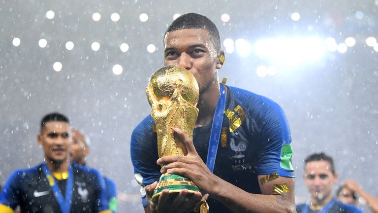 Kylian Mbappe celebrates with the World Cup trophy