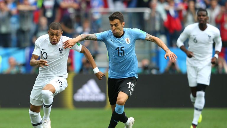Kylian Mbappe and Matias Vecino in action during the 2018 FIFA World Cup quarter final between Uruguay and France