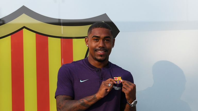 Barcelona's new signing Malcom poses for photographs during his unveiling at the Camp Nou on July 24, 2018