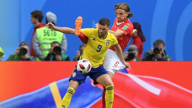 Marcus Berg tussles with Michael Lang (R) in Saint Petersburg