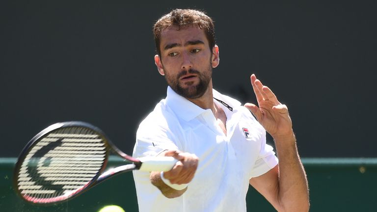 Croatia's Marin Cilic returns to Japan's Yoshihito Nishioka during their men's singles first round match on the first day of the 2018 Wimbledon Championships at The All England Lawn Tennis Club in Wimbledon, southwest London, on July 2, 2018.