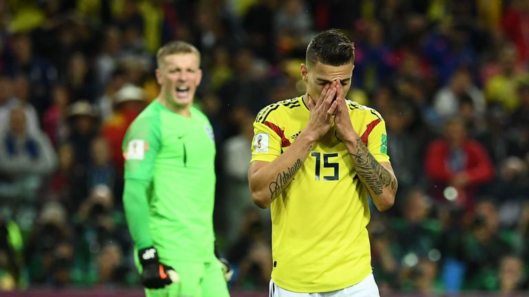 Mateus Uribe reacts to missing his penalty in the shootout while Jordan Pickford (rear) celebrates