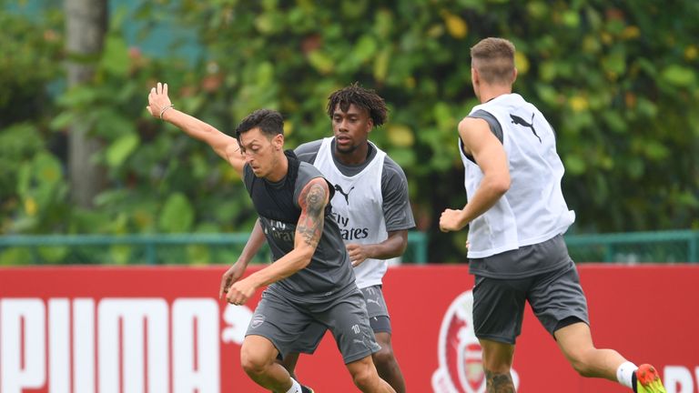 Mesut Ozil and Alex Iwobi in action during a training session at Singapore American School on July 25, 2018