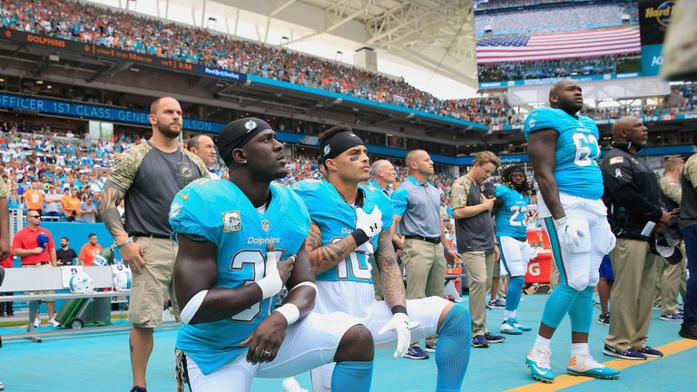 Michael Thomas #31  and Kenny Stills #10 of the Miami Dolphins take a knee during the national anthem 