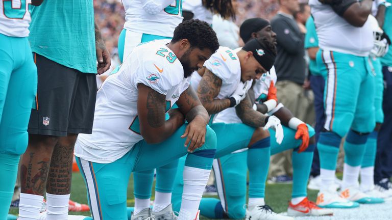 Arian Foster #29, Kenny Stills #10 and Michael Thomas #31 of the Miami Dolphins kneel during the national anthem in 2016