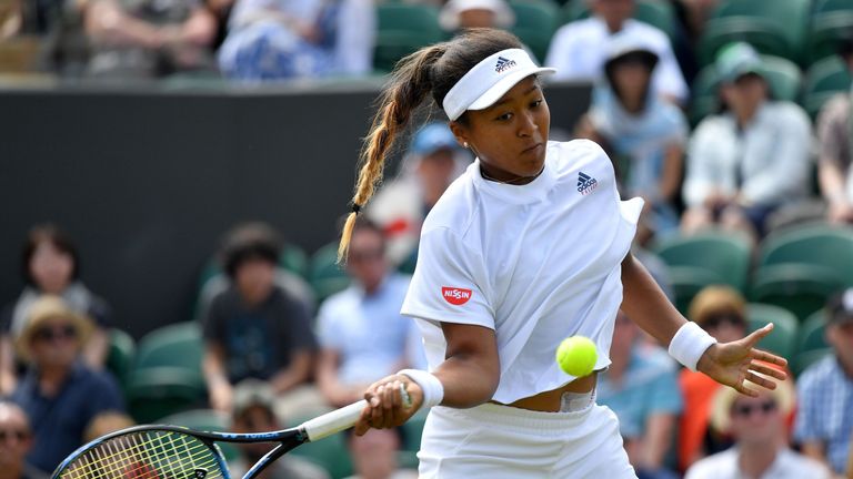 Japan's Naomi Osaka returns against Britain's Katie Boulter during their women's singles second round match on the fourth day of the 2018 Wimbledon Championships at The All England Lawn Tennis Club in Wimbledon, southwest London, on July 5, 2018. 