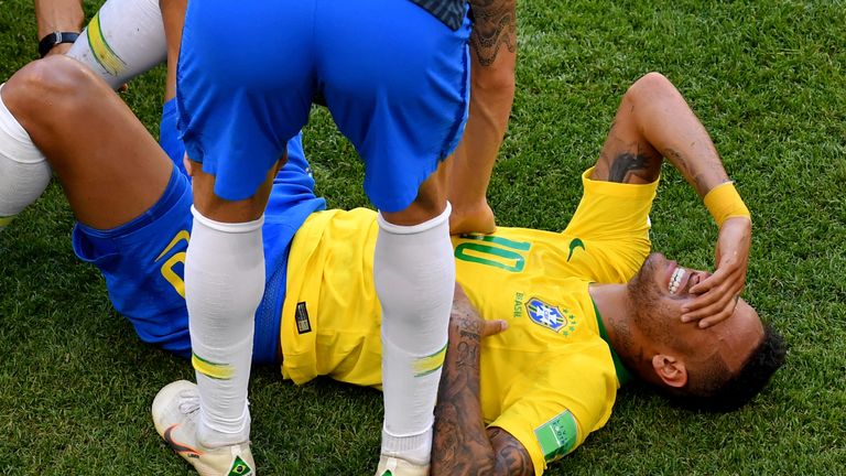 Neymar winces after going down injured on the touchline