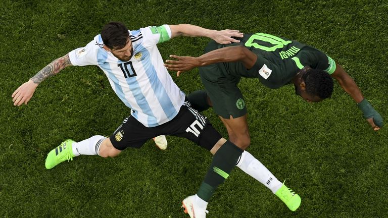 Mikel tussles with Argentina's Lionel Messi just hours after being told his father had been kidnapped