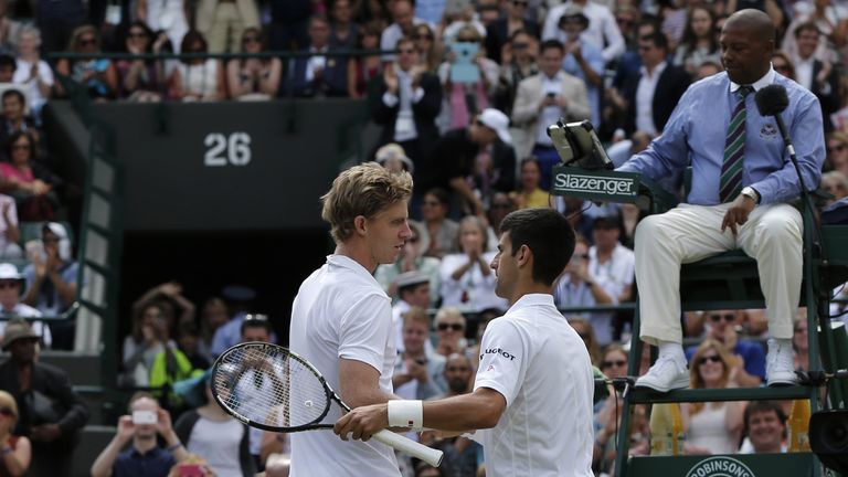 Serbia's Novak Djokovic (R) shakes hands with South Africa's Kevin Anderson (L) after winning their men's singles fourth round match on day eight of the 2015 Wimbledon Championships at The All England Tennis Club in Wimbledon, southwest London, on July 7, 2015.