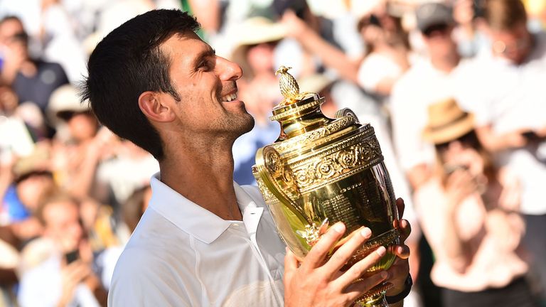Serbia's Novak Djokovic poses with the winners trophy after beating South Africa's Kevin Anderson 6-2, 6-2, 7-6 in their men's singles final match on the thirteenth day of the 2018 Wimbledon Championships at The All England Lawn Tennis Club in Wimbledon, southwest London, on July 15, 2018