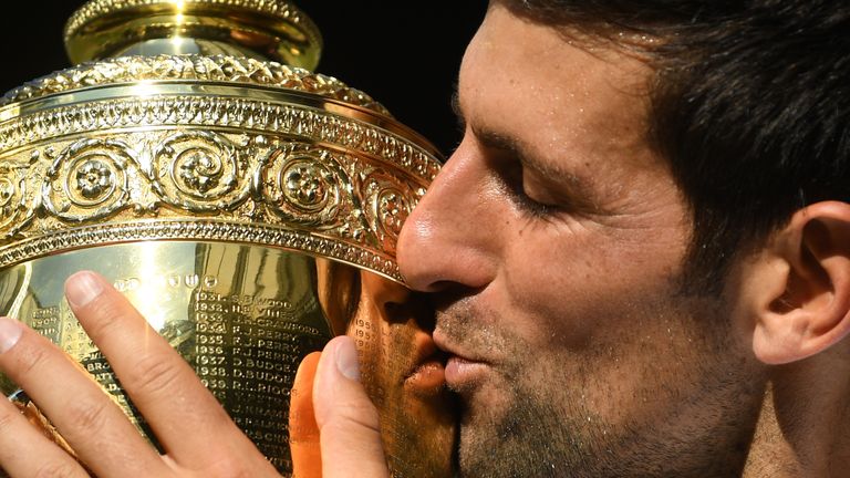 Serbia's Novak Djokovic kisses the winners trophy after beating South Africa's Kevin Anderson 6-2, 6-2, 7-6 in their men's singles final match on the thirteenth day of the 2018 Wimbledon Championships at The All England Lawn Tennis Club in Wimbledon, southwest London, on July 15, 2018. 