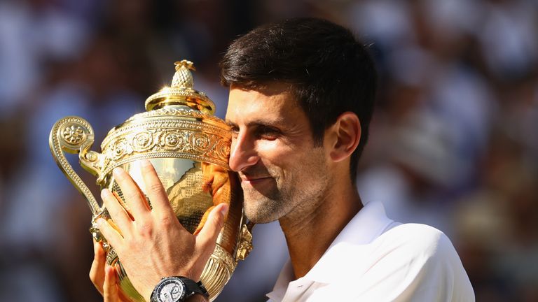 Novak Djokovic of Serbia shows off the trophy after winning the Men's Singles final against Kevin Anderson of South Africa on day thirteen at All England Lawn Tennis and Croquet Club on July 15, 2018 in London, England