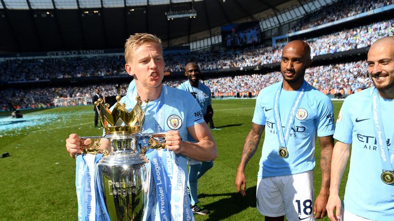 Oleksandr Zinchenko celebrates with the Premier League trophy after the match between Manchester City and Huddersfield Town at Etihad Stadium on May 6, 2018