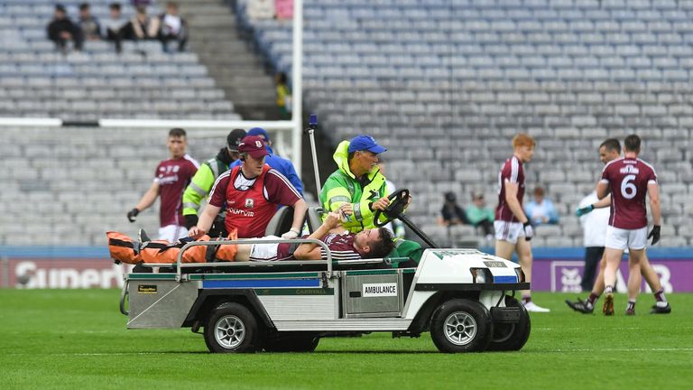 Paul Conroy of Galway is helped off the field on a stretcher, and it was later revealed that he suffered a double leg-break
