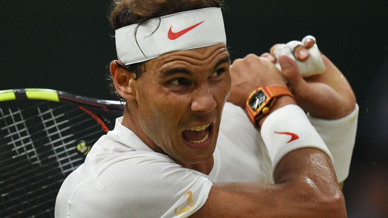 Spain's Rafael Nadal returns against Serbia's Novak Djokovic during their men's singles semi-final match on the eleventh day of the 2018 Wimbledon Championships at The All England Lawn Tennis Club in Wimbledon, southwest London, on July 13, 2018. 