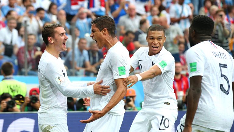 Raphael Varane celebrates his goal with team-mates Kylian Mbappe and Antoine Griezmann