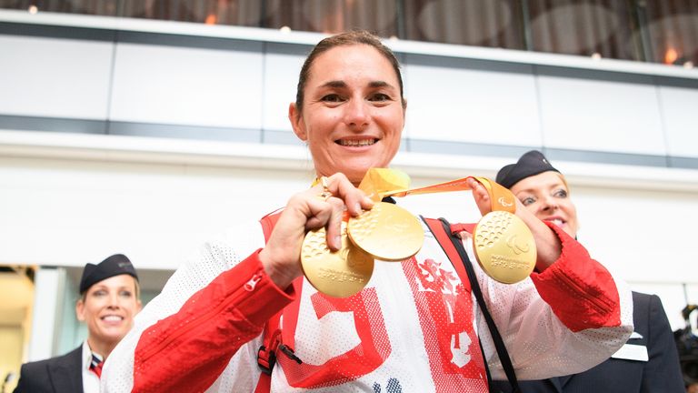 Gold medallist Sarah Storey (C) walks into the arrivals area after arriving on British Airways flight BA2016 from Rio de Janeiro to London Heathrow Terminal 5 on September 20, 2016 in London, England. 