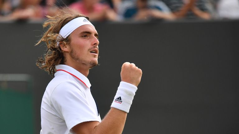 Greece's Stefanos Tsitsipas celebrates a point against US player John Isner in their men's singles fourth round match on the seventh day of the 2018 Wimbledon Championships at The All England Lawn Tennis Club in Wimbledon