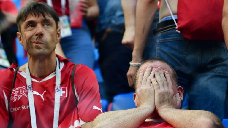 Switzerland fans react after the team lost the Russia 2018 World Cup round of 16 football match between Sweden and Switzerland at the Saint Petersburg Stadium in Saint Petersburg on July 3, 2018