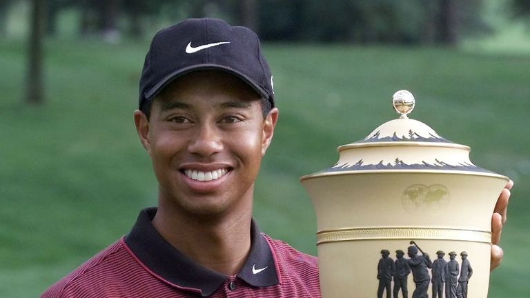 Tiger Woods of the US holds the 'Gary Player Cup' 29 August 1999 after winning the NEC Invitational of the World Golf Championships at Firestone Country Club in Akron, Ohio. 
