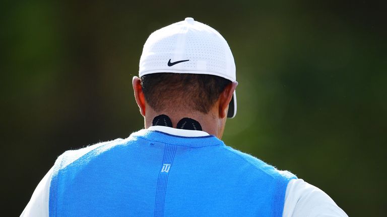 Woods arrived at the course with his neck taped