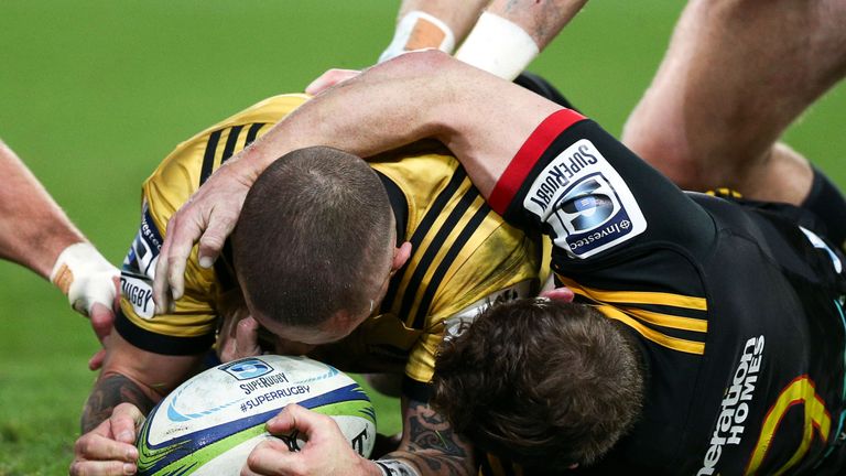 TJ Perenara of the Hurricanes scores a try in the tackle of Brad Weber of the Chiefs during the Super Rugby Qualifying Final match between the Hurricanes and the Chiefs at Westpac Stadium on July 20, 2018 in Wellington, New Zealand. 
