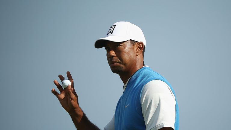 Tiger Woods salutes the gallery