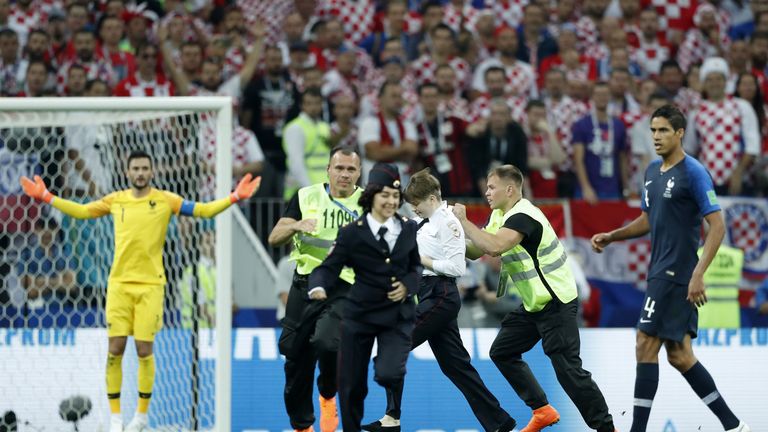 Pitch invaders are apprehended during the World Cup final