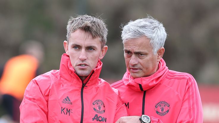 Manchester United first team coach Kieran McKenna in discussion with manager Jose Mourinho during a training session at the club's Aon Training Complex