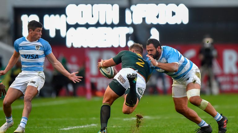 South Africa's hooker Malcolm Marx (C) is tackled by Argentina's tight-head prop Juan Figallo during The Rugby Championship rugby union match between South Africa and Argentina at Johnson Kings Park Stadium in Durban on August 18, 2018. 