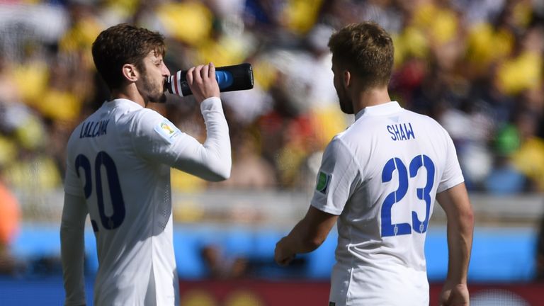 England's midfielder Adam Lallana (L) drinks as England's defender Luke Shaw walks during the Group D football match between Costa Rica and England at The Mineirao Stadium in Belo Horizonte on June 24, 2014,during the 2014 FIFA World Cup . AFP PHOTO / FABRICE COFFRINI
