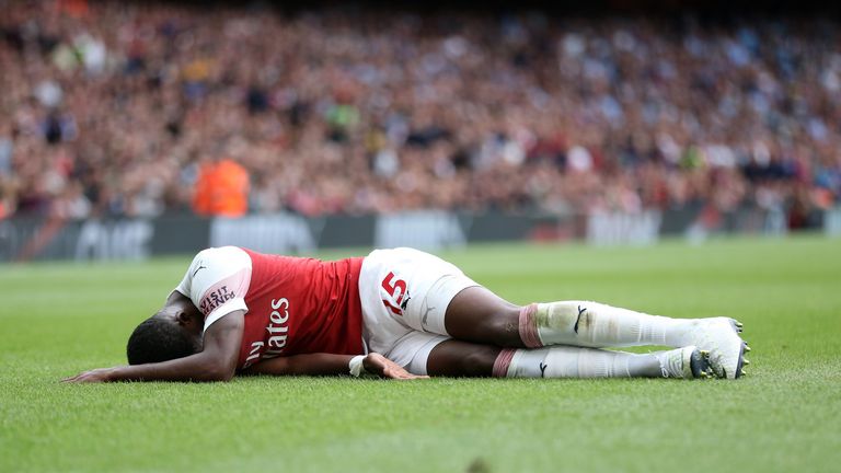 Ainsley Maitland-Niles lies injured at the Emirates Stadium during Sunday's Premier League match against Manchester City