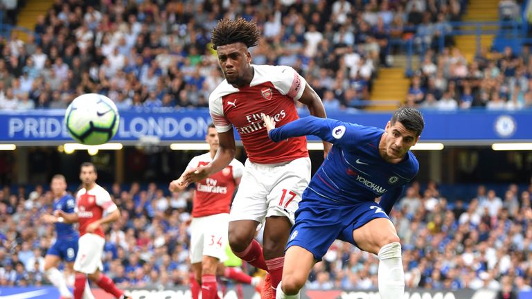 Alex Iwobi of Arsenal battles for possession with Alvaro Morata of Chelsea during the Premier League match between Chelsea FC and Arsenal FC at Stamford Bridge on August 18, 2018 in London, United Kingdom