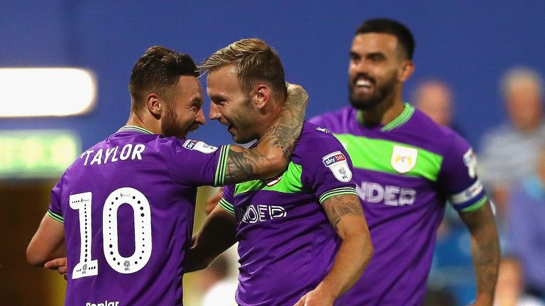 Andreas Weimann of Bristol City (center) celebrates after scoring his sides second goal during the Sky Bet Championship match between Queens Park Rangers and Bristol City at Loftus Road