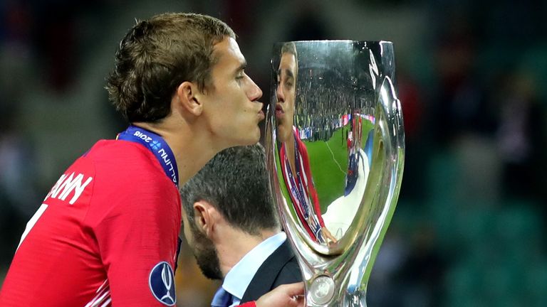 Antoine Griezmann kisses the trophy after Atletico Madrid's 4-2 defeat of Real Madrid at Lillekula Stadium on August 15, 2018