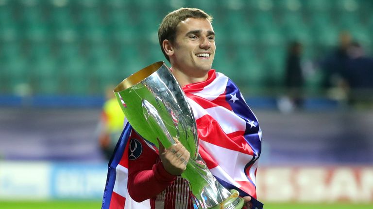 Antoine Griezmann celebrates with the trophy following the UEFA Super Cup between Real Madrid and Atletico Madrid at Lillekula Stadium on August 15, 2018