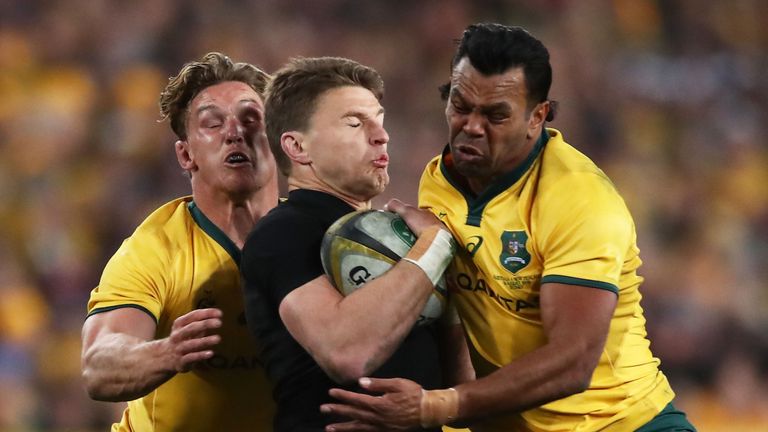 Beauden Barrett of the All Blacks is tackled by Michael Hooper (L) and Kurtley Beale (R) of the Wallabies