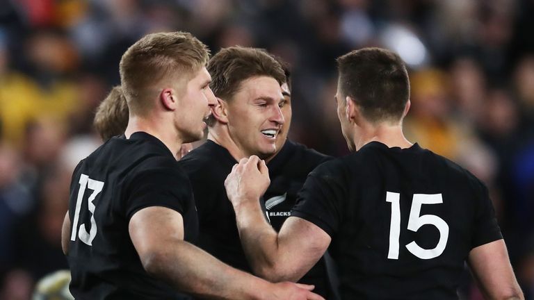 Beauden Barrett of the All Blacks celebrates with team-mates after scoring against Australia