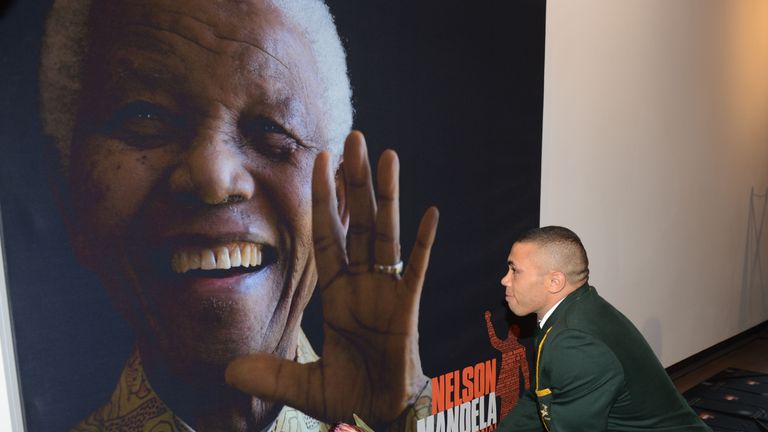 Bryan Habana lays flower during the launch event of the Nelson Mandela Sports Day