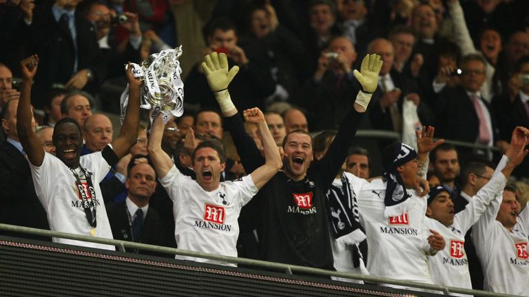 Ledley King lifts the Carling Cup with Robbie Keane following victory over Chelsea in 2008