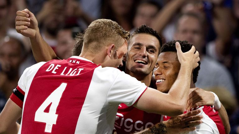 Ajax's Brazilian forward David Neres (R) celebrates with teammates after scoring their 3-0 goal against Standard Liege