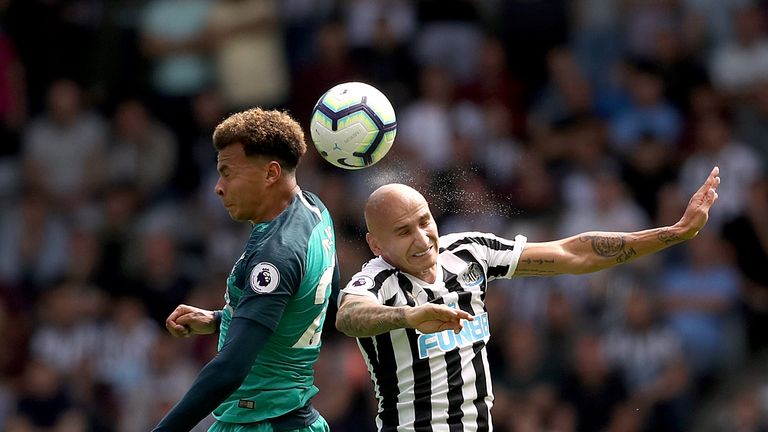 Dele Alli and Jonjo Shelvey compete in the air at St James' Park