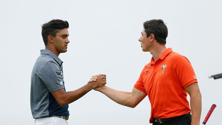 Devon Bling (left) of the United States and Viktor Hovland of Norway shake hands after the first round of the championship match for the U.S. Amateur Championship at Pebble Beach Golf Links on August 19, 2018 in Pebble Beach, California. 