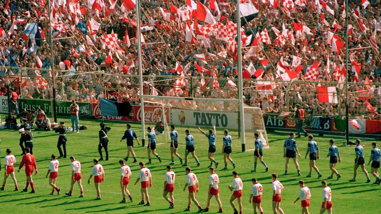 The Dublin and Tyrone teams follow the parade before throw-in