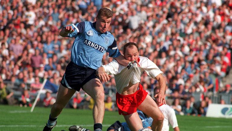 Redmond holds off Paul Devlin to score the only goal of the game