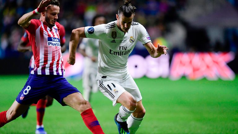 Gareth Bale evades a challenge from Saul Niguez