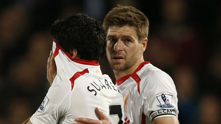 Liverpool's English midfielder Steven Gerrard (R) shepherds Liverpool's Uruguayan striker Luis Suarez (L) from the field as he reacts at the end of the English Premier League football match between Crystal Palace and Liverpool at Selhurst Park in south London on May 5, 2014.